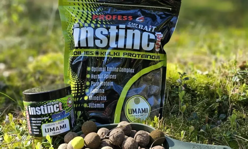 Profesjonalne kulki na karpia Instinct Umami w słoiczku i opakowaniu. Na łopatce widoczne są gotowe do użycia kulki proteinowe.